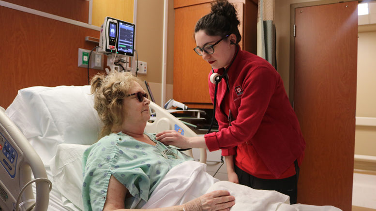 A nurse on the 9N Adult Surgical Unit checks a patient’s vital signs during morning rounding.