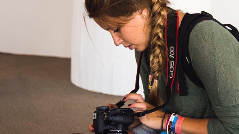 Grace Hollars, Ball State '19, examines her camera while participating in the university's immersive learning experience BSU at the Games in Rio in 2016. Hollars is returning to the Olympics through BSU at the Games this winter to cover the 2018 Games in South Korea. Photo provided