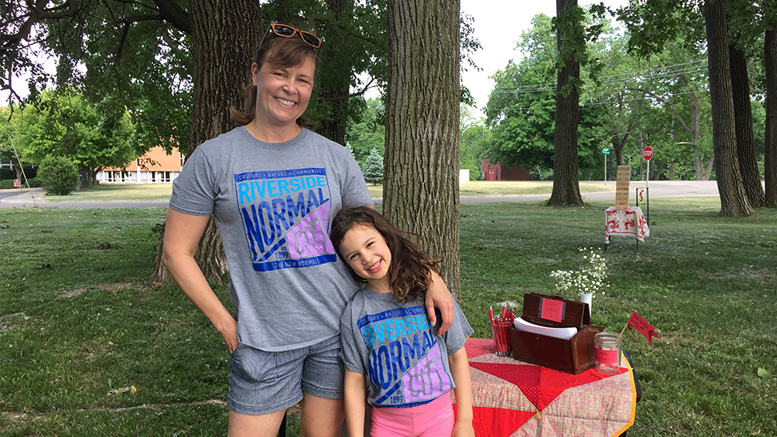 Normal City residents Jen Erickson and her daughter Anika wearing their neighborhood t-shirts while setting up for the June 2nd RNC summer picnic. Photo provided.