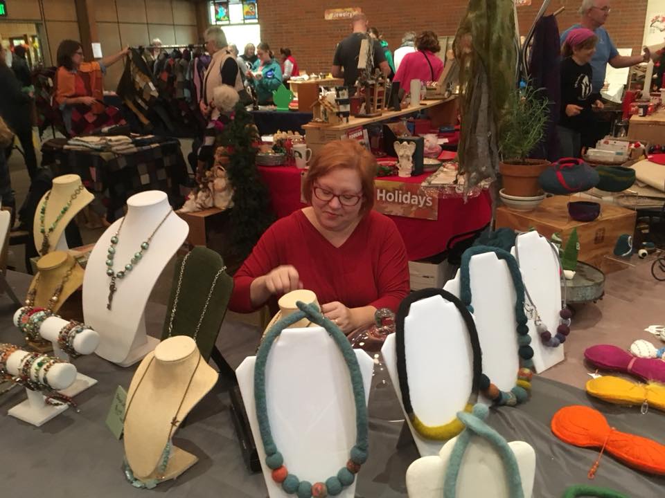 Margaret Reeder is pictured in a jewelry booth. 