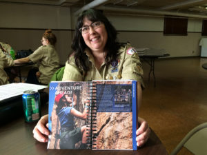 Tori Norris Murphy holds the girls’ version of the Scouts BSA Handbook. Photo by: John Carlson