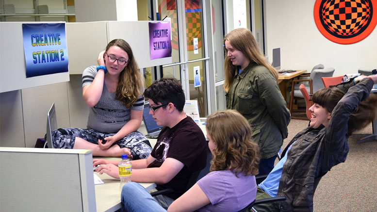 Students editing their video as a team during Summer Film School. Photo by: Stuart Cotton, Muncie Public Library