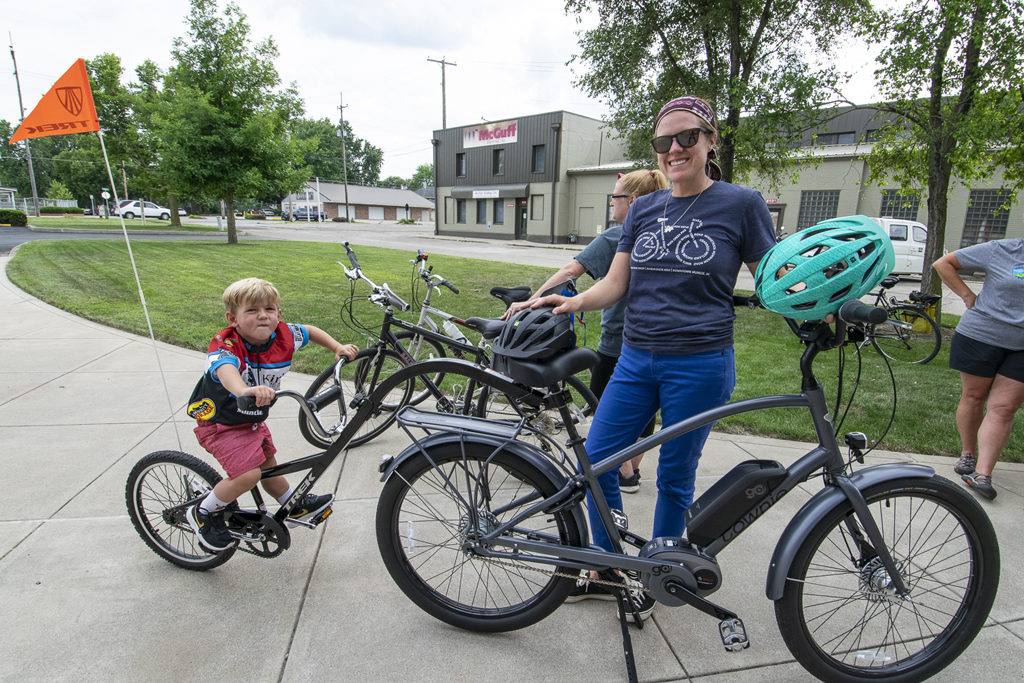This little boy's bike is attached to his mom's through a tandem system as they pose for a photo prior to the community group ride. Photo by: Mike Rhodes