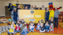 Members of the Pacers organization, community leaders, children and Santa are pictured during the toy giveaway at the Mitchell Early Childhood and Family Center. Photo by: Mike Rhodes