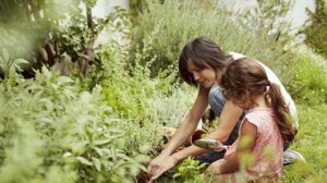 Mother and daughter gardening. Photo provided by State Farm Insurance