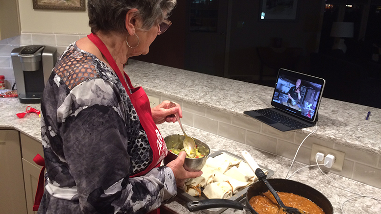 One eye on her iPad and one on her bowl, Nancy makes some fresh guacamole. Photo by John Carlson