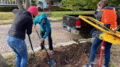 BSU student volunteers help dig a hole to plant a tree along North Street. Photo by Heather Williams