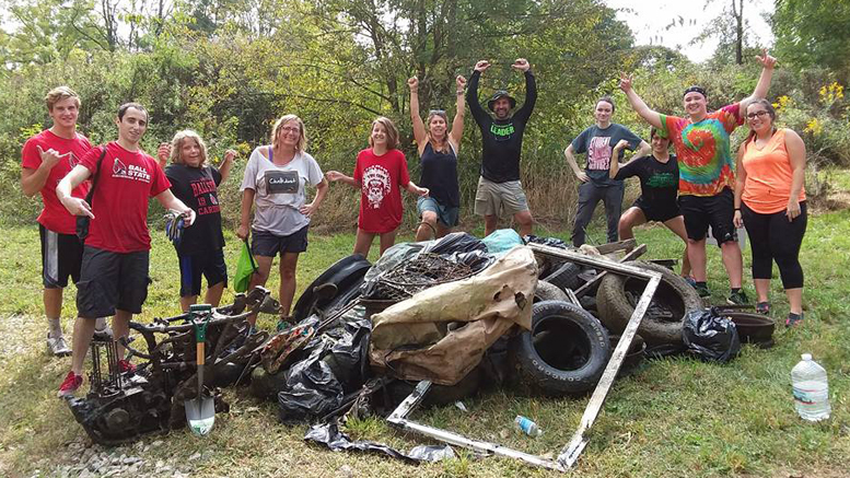 Canoe group volunteers pose with their haul of trash rescued from the White River at the 2017 clean-up event.