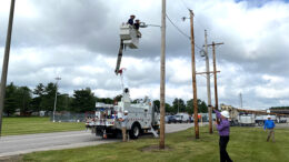 Muncie Mayor Dan Ridenour is pictured in the bucket truck during a mock demonstration of the streetlight conversion. WLBC's Steve Lindell is seen below, videotaping the mayor. Photo provided by Indiana & Michigan Power