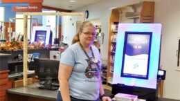Laura Geesy, MPL employee, with one of the new RFID checkout units. Photo by Susan Fisher