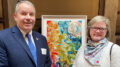 Carrie Wright is pictured with Indiana Senator Scott Alexander along with her hand painted silk artwork. Photo provided