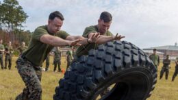 U.S. Marine Corps 1st Lt. Jacob D. Durfee (left), an assistant operations officer, and Capt. Francesco A. Rojas (right), an infantry officer, both with 1st Battalion, 2nd Marines, 2nd Marine Division, perform tire lifts during a field meet in commemoration of Tarawa Day on Marine Corps Base Camp Lejeune, North Carolina, Nov. 19, 2025. U.S. Marine Corps photo by Lance Cpl. Carla Perez Ramirez.