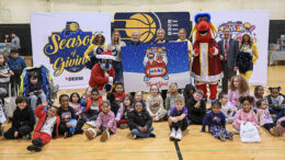 Children gather with Pacers Sports & Entertainment staff, Indiana Pacers mascot Boomer, Indiana Fever mascot Freddy Fever, Indiana Pacemates, Muncie Mayor Dan Ridenour and Muncie Police Department Deputy Chief Melissa Criswell for the Big Toy Giveaway at Muncie Central High School on Tuesday, Dec. 9, 2025.