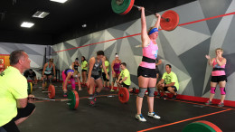 Female competitors performing WOD 1 Cluster ladder during Downtown Throwdown II.