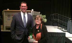 Jud Fisher is pictured with Juli Metzger and the John W. and Janice B. Fisher Governance Award she received. Photo provided.