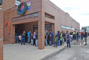 The line to see Santa wraps around the fire station.