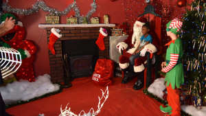 A young child visits with Santa at last years event. File photo.