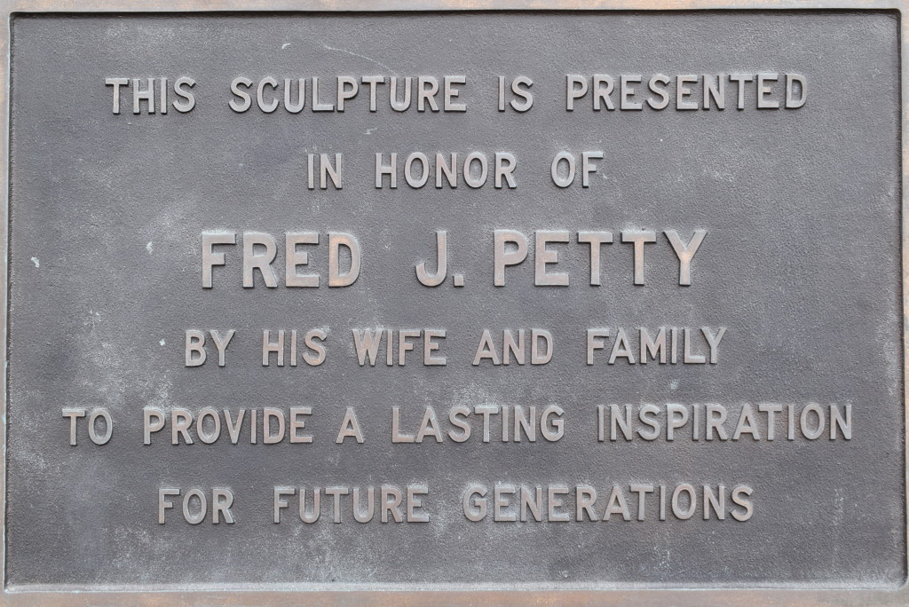 The plaque at the base of the Passing of the Buffalo sculpture.