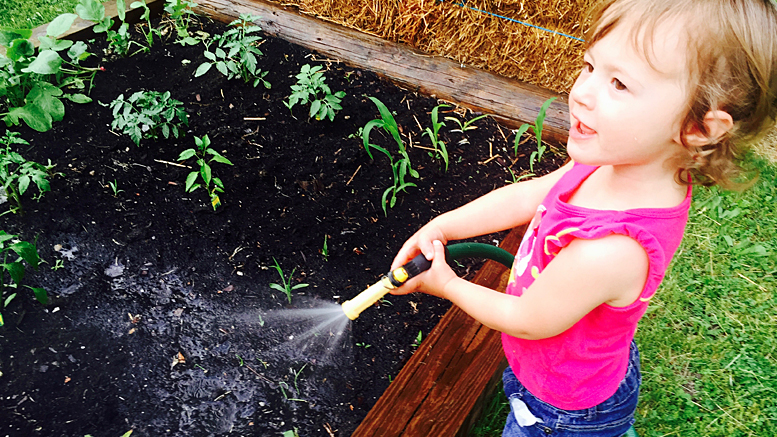 Learning to water the garden. Photo by: Matt Howell