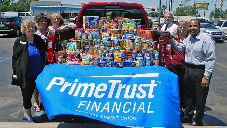 PrimeTrust staff and a representative from Second Harvest Food Bank and Dellen Ford pose with the 651 pounds of food collected during the Fill-A-Truck event sponsored by PrimeTrust during the months of April and May. Photo provided.