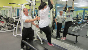 On and off the floor, Studio 22 client Lyla Spath works out under the watchful eyes of fitness coach Brad Warner. Photo by: John Carlson