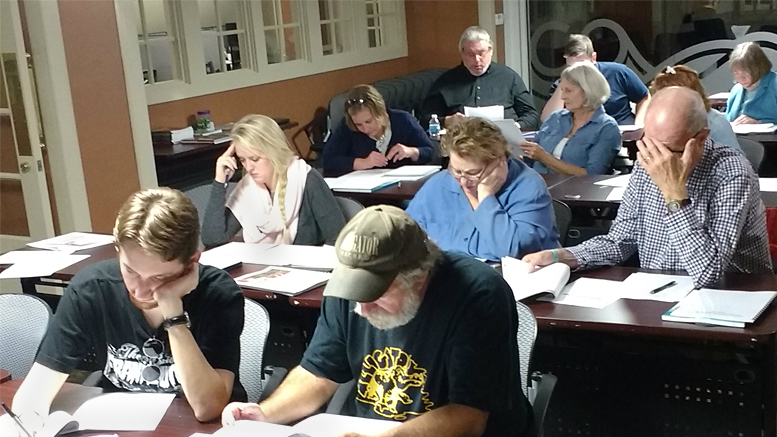 Volunteer tutors study during the new tutor orientation, held in downtown Muncie’s CO:Lab. Photo provided.