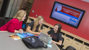 Public relations students Hannah Riffle and Katie Ronzio work with Deborah Davis, their program's coordinator. Riffle and Ronzio are organizing the Public Relations Student Society of America's 2016 National Conference Oct. 21-25 in Indianapolis. Photo provided.