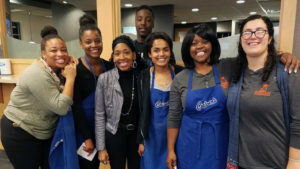 From left: Teanna Evans, Lanisha Huggins, Tamica Crumes, Kara Sage, Jeannine Lee Ferrer and Mary Snyder. Standing in the back of the women is George Huggins, whose parents started Feed My Sheep in 1996. File photo