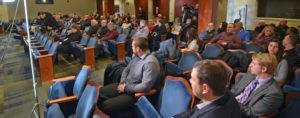 Audience members attending the news conference in the City Hall Auditorium.