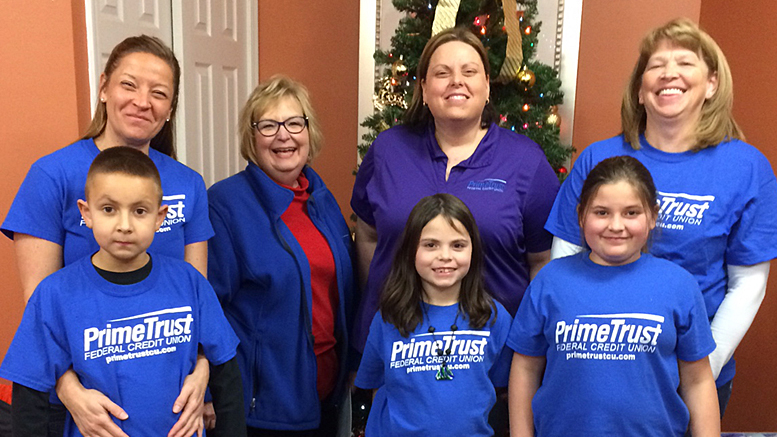 PrimeTrust Federal Credit Union employees and their children deliver holiday cards and carol at Signature HealthCARE of Muncie. Photo provided.