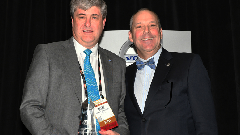 Jeff Lester (right), senior vice president of sales for Volvo Trucks North America, presents Steve Bassett, General Truck Sales dealer principal, the award for the 2016 Volvo Trucks North American Dealer of the Year.