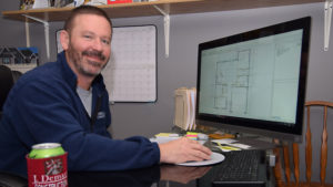 Jay Demaree is pictured in his office reviewing some recent project drawings.