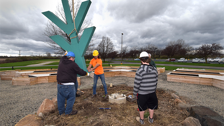 The Ivy Tech totem was installed in the center of the gardens at 1:15pm on April 4th. Photo by: Mike Rhodes