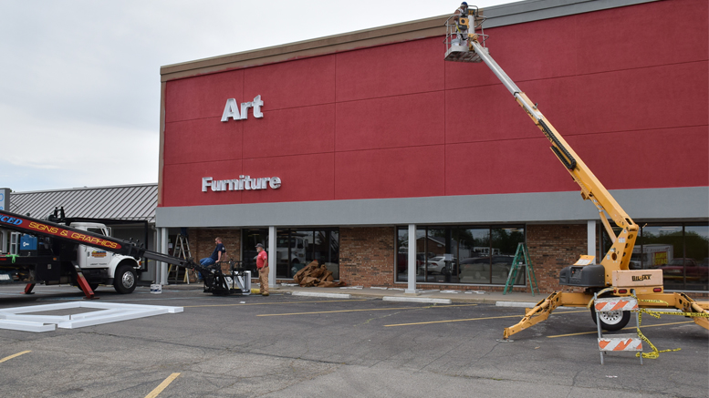 Signage installers and painters working at the new Art Van Furniture location in Muncie.