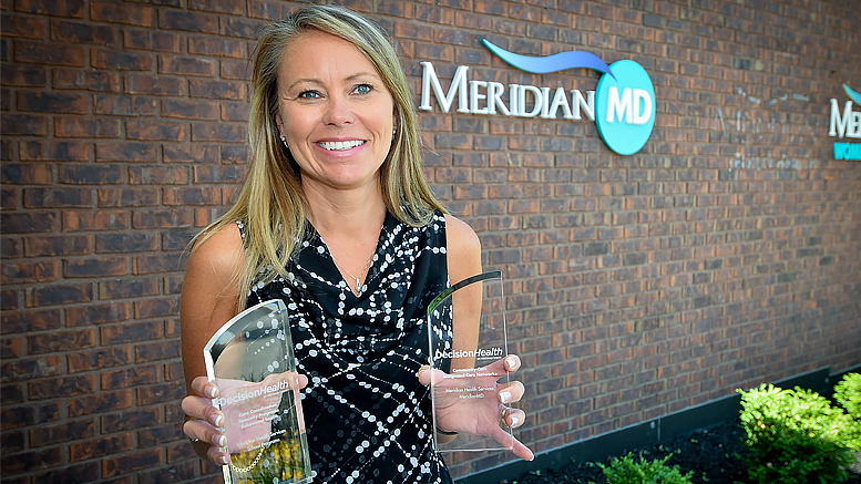 Pictured holding the awards—Jennifer Henderson, Director of Primary Care. Photo by: Mike Rhodes