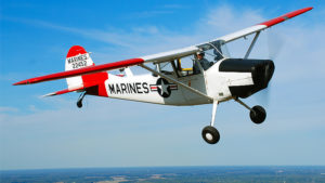 Bill Finney flying his L-19 Bird Dog through blue skies. Photo by: Kevin Tanner/Air Classics magazine