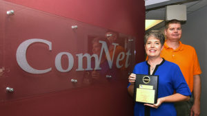 ComNet owners, Mindy and Tom Kemper are pictured with their 13th ATSI award. Photo by: Mike Rhodes