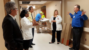 As the 9N Adult Surgical Unit remodel comes to a close, leaders take a tour and learn about the space and upgrades. From left to right: IU Health East Central Region President Dr. Jeff Bird, Administrative Director of Medical/Surgical Services Chanel Venable, IU Health Executive Vice President and Chief Operating Officer Al Gatmaitan, construction engineers in the background, Clinical Operations Manager Teresa Elliott, and Projects and Plant Operations Manager John Ward.