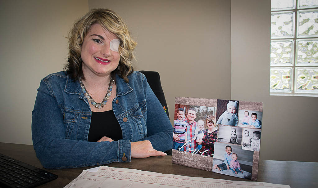 Brittani Richards is pictured in her Thrive Credit Union office with photos of her family. Photo by: Mike Rhodes