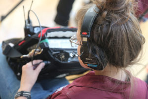 Ball State student Ivie Hiller checks sound levels on the set of “Amplified: A Conversation with Women in American Film Sound.” Ball State students Vince Foley and Vanessa Lauby operate a camera on the set of “Amplified: A Conversation with Women in American Film Sound.” Photo by: Laura Huffman