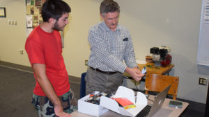 Stefan Brandle, Ph.D., professor of computer science and engineering at Taylor University works with a student at PhyxtGears. Photo by: Mike Rhodes