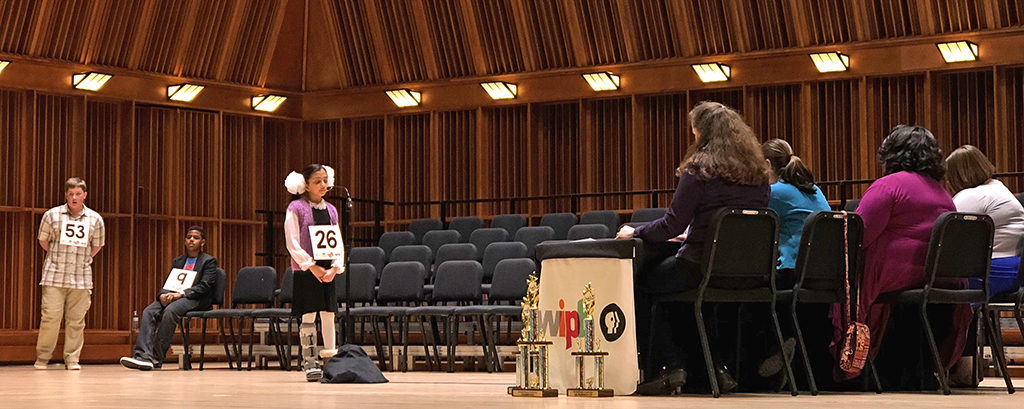 Burris Laboratory School student Alesya Rathinasamy, at the microphone spelling a word, is the winner of the third WIPB-TV Spelling Bee. Photo provided.