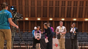 2018 WIPB-TV Spelling Bee Champion is interviewed by host Michelle Kinsey during the awards ceremony. Andrew Toney and Samori McKell-Jeffers stand by, holding their first runner-up and second runner-up trophies, respectively. Photo provided.