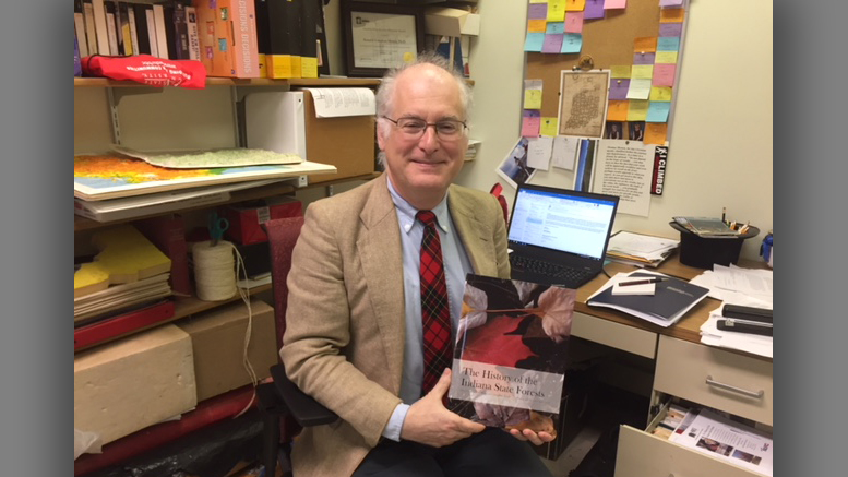 Ball State history professor Ron Morris is pictured with his new book, “The History of Indiana State Forests.” Photo provided.