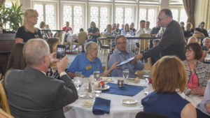 Rear Adm. Sam Cox (Ret.), Director of Naval History and Heritage Command, right, presents Arthur Leenerman, an Indianapolis survivor, with a certificate of appreciation during the 2018 USS Indianapolis reunion. Photo by: Lindsay A Metler