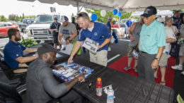 Jack Doyle and Robert Mathis sign autographs and give posters to fans at the Toyota and Kia of Muncie Tent Sale. Photo by: Mike Rhodes