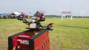 A racing drone in a line of 8 is pictured on the launch pad getting ready to launch. Photo by: Mike Rhodes