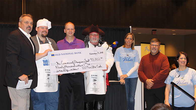 Jeff Howe, far left, receives a check from the presenting sponsors of 100 Men Who Cook for the Community Champions Fund in the amount of $90,002.77. Photo provided
