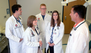 Family medicine residents at the IU Health Ball Family Medicine Residency listen as Christian Shue, DO, explains a procedure.