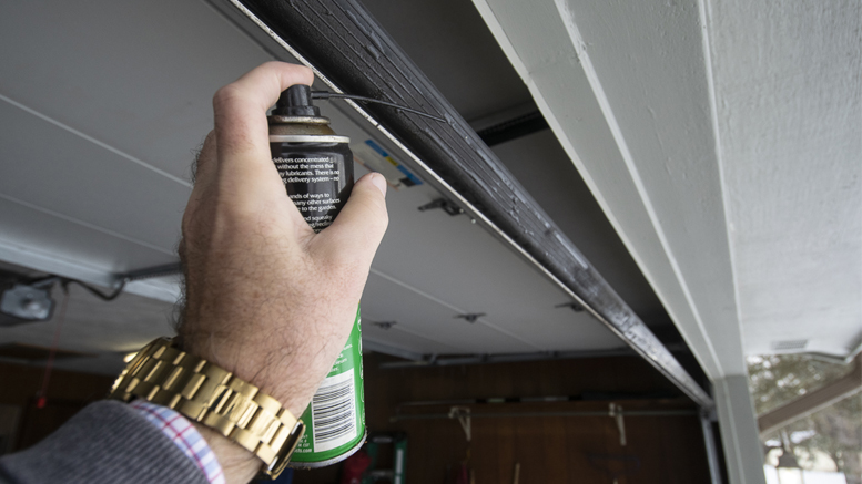 Spraying a silicone-based lubricant on the rubber base of your garage door will keep it from sticking/freezing to the pavement in very cold weather. Photo by: Mike Rhodes
